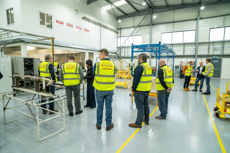 Visitors pictured being taken on a tour around Preformed Windings' new Unit J facility, with a member of staff answering questions and demonstrating equipment
